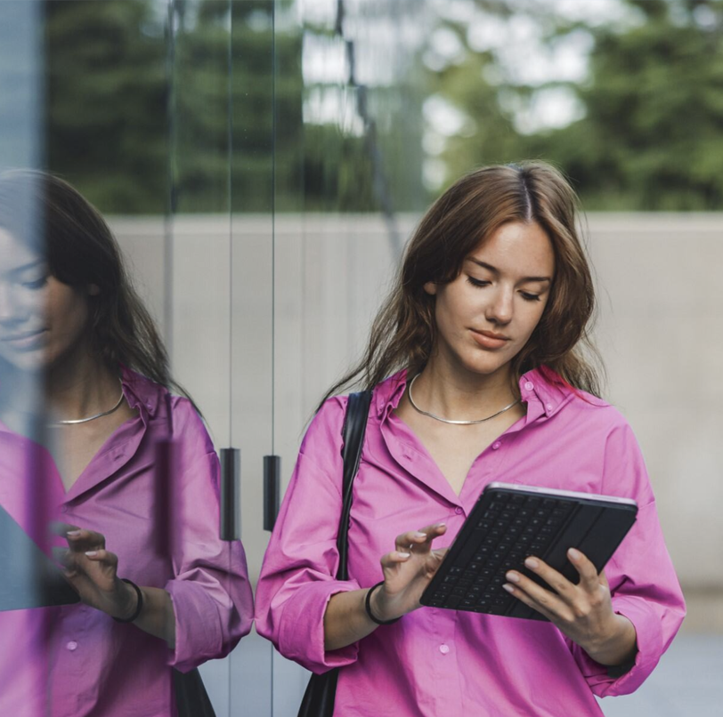 Woman in pink holding a tablet