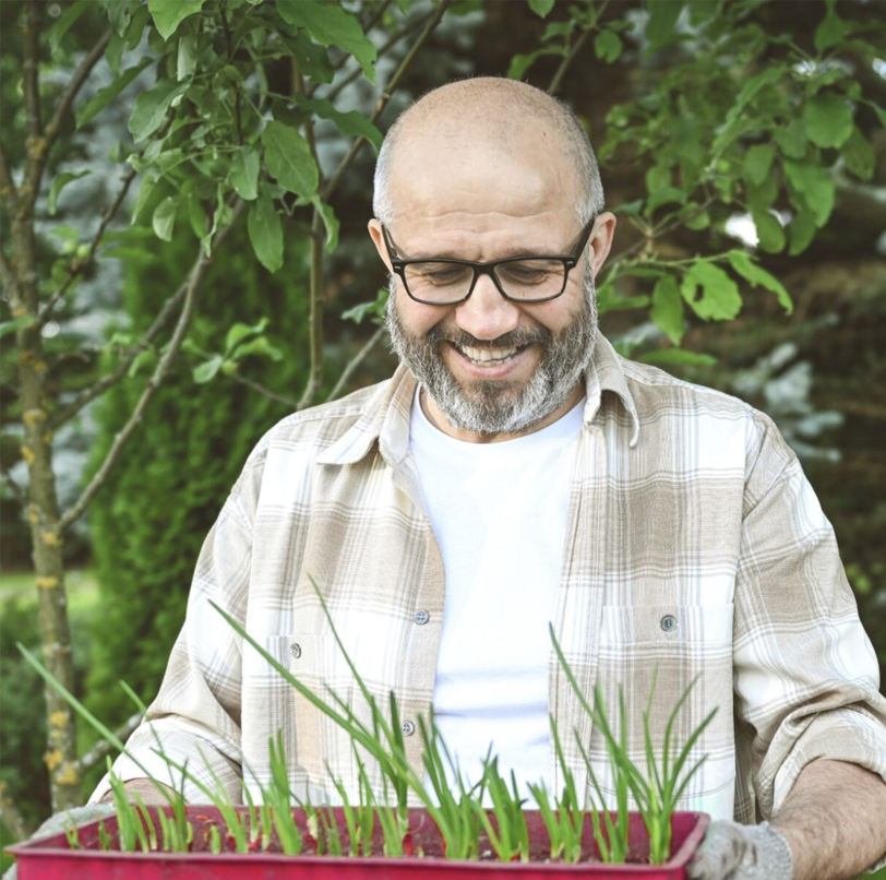 A mature man gardening